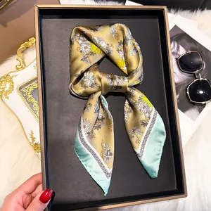 Detail of floral silk square scarf with daisy print in an elegant luxury gift box