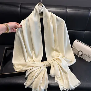 Detail of silk-blend long scarf with butterfly jacquard pattern and fringe edges