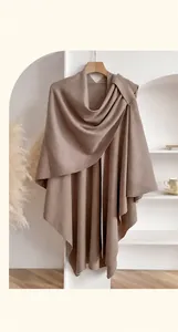 Close-up of soft mocha knitted shawl wrap with elegant draped texture and scarf collar