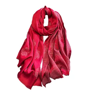 Elegant red silk shawl featuring golden camellia patterns with stylish fringe edges