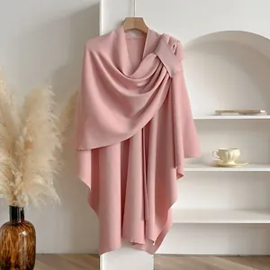Elegant light pink knitted shawl poncho for women with a natural asymmetrical draped hem