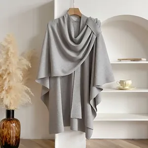 Elegant grey knitted poncho cape for women featuring a soft texture and natural drape