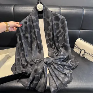 Detalle de bufanda de seda con estampado de leopardo, hilo plateado y flecos finos