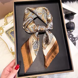 Retro paisley silk scarf tied in a bow inside a premium black gift box packaging