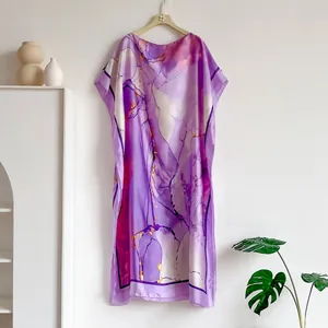 Detail of purple marble print silk satin kaftan dress with artistic drapery and texture