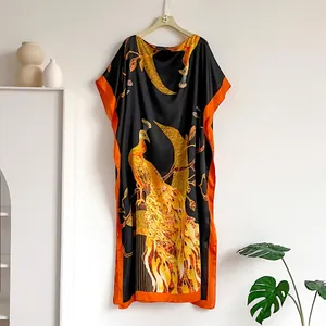 Elegant black silk kaftan dress with golden peacock print and orange trim detailing