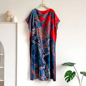 Detailed close-up of colorful floral print on high-quality silk-like maxi dress fabric