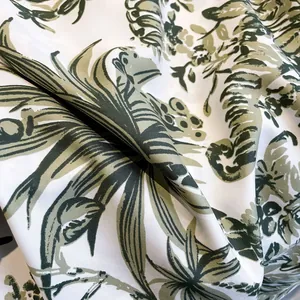 Women's silk-like square scarf featuring tropical green leaf patterns on white fabric