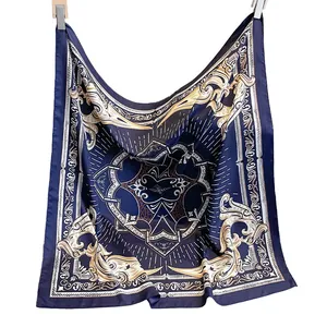 Navy blue silk scarf with golden baroque patterns shown in a natural draped hang