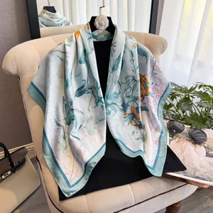 Elegant 90cm mint green silk scarf with tropical leaf print on stylish armchair