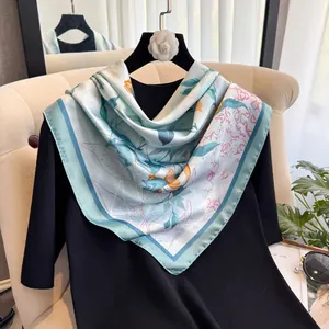 Floral satin silk square scarf in mint green and orange on a minimalist hanger
