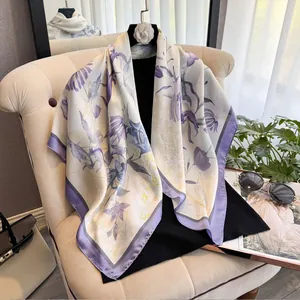 Elegant purple floral printed square silk scarf displayed on a chair with accessories
