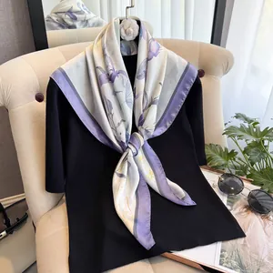 Close-up of elegant floral silk scarf with light purple pattern on a boutique display
