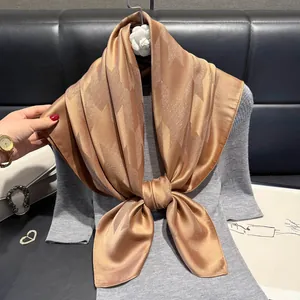 Elegant champagne gold silk scarf with houndstooth pattern and metallic luster finish