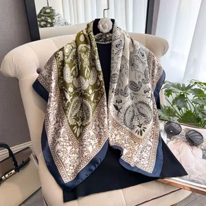 Detailansicht eines luxuriösen Seidenschals mit Paisley-Muster und modischen Accessoires