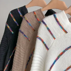 Detailed macro view showing the soft ribbed knit texture and rainbow striped patterns