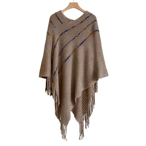 Thick knit bohemian poncho for women with colorful stripes and fringe hem details