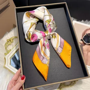 Detail of silk scarf with retro floral pattern displayed on a luxury setting