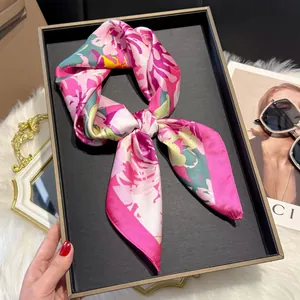Pink floral faux silk square scarf with vintage paisley pattern shown on a display tray
