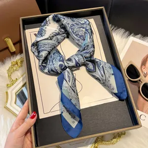 French elegant paisley print silk scarf in blue and white displayed in a premium gift box