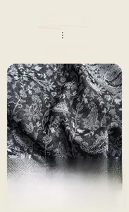 Detailed texture of black and white paisley jacquard scarf in soft imitation cashmere