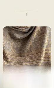 Macro detail of paisley pattern cashmere-like scarf with warm golden and brown texture