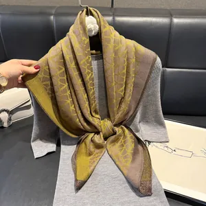 Elegant silk-like scarf with geometric gold print and metallic gold border decoration