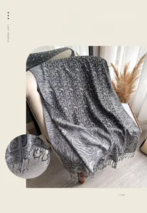 Close-up of elegant paisley jacquard scarf with fine fabric texture and tassel fringe edges