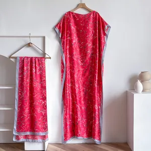 Detail of red floral kaftan dress with satin borders and matching scarf set
