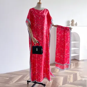 Red silk-like kaftan dress set with silver abstract prints and matching shawl on mannequin