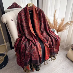 Close-up of paisley patterns and handmade tassels on a bohemian retro winter shawl