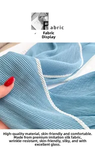 Macro detail of pleated faux silk scarf showing light blue texture and woven edge