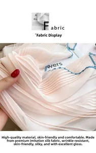 Detailed macro view of pleated silk-like fabric in light pink with blue border trim