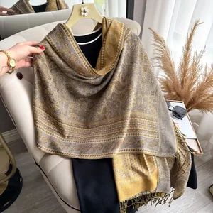 Detail of ginger paisley jacquard scarf with fine tassels and thick woven texture