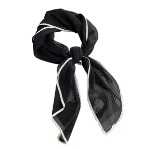 Elegant pleated black sheer scarf with white contrast edges tied in a decorative bowknot