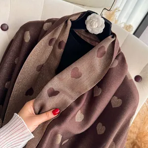 Detail of dark brown heart pattern scarf with subtle gold lurex metallic glitter threads