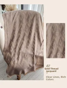 Detailaufnahme der braunen Goldfaden-Jacquard-Schal mit Ethno-Rautenmuster und Fransen