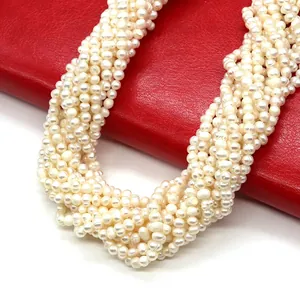 Detailed macro view of multi-strand natural freshwater pearl necklace on red leather