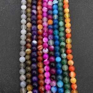 Detailed view of colorful striped agate beads in vibrant purple, blue, green, and orange