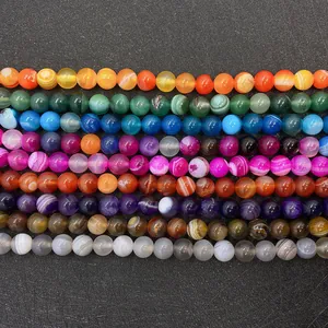 Macro view of colorful striped agate beads in various sizes for DIY jewelry making