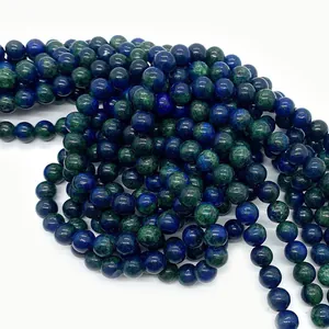 Macro detail of natural blue azurite and green malachite round beads with polished texture