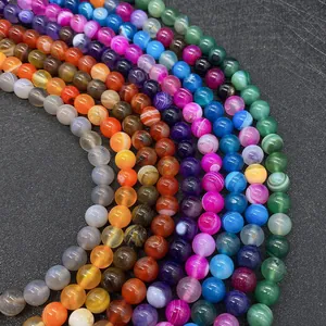 Macro shot of colorful striped agate beads in pink purple blue and green for DIY jewelry