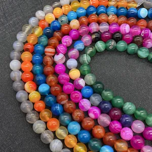 Close-up of vibrant striped agate round beads in multiple colors for DIY jewelry making