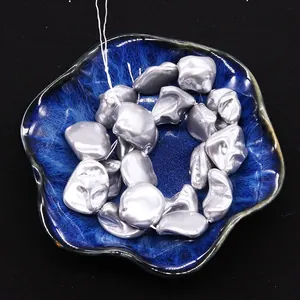 Close-up of irregular silver baroque style shell beads for DIY jewelry making
