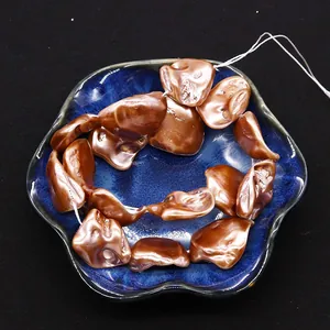 Detailed macro view of irregular bronze shell beads for DIY jewelry making