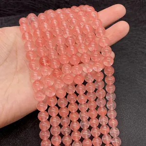 Macro view of hand-held pink watermelon crystal beads with natural ice crack texture