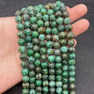 Macro detail of natural African pine stone round beads showing unique green textures