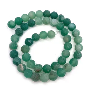 Macro view of matte green natural stone round beads for DIY jewelry making