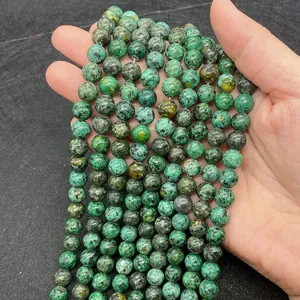 Detailed view of round green African Turquoise natural stone beads with unique marbled texture