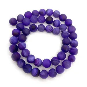 Macro detail of matte purple striped agate beads showing natural stone texture and frosted finish